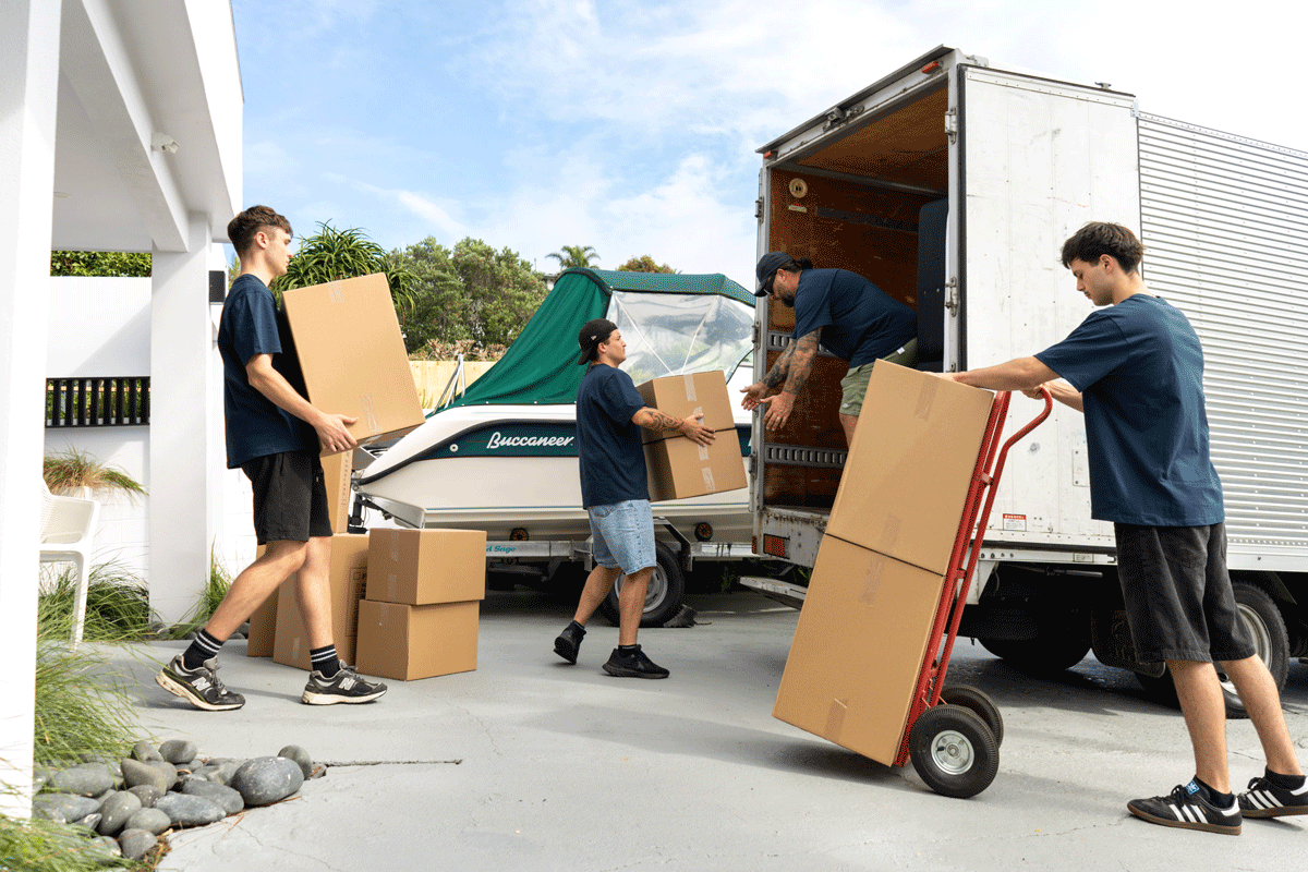 Professional moving team loading boxes into a moving truck